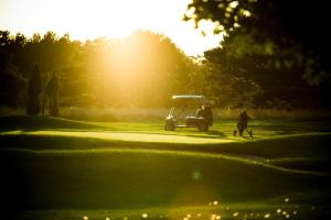 a golf cart parked on a golf course at Casa Belvedere in Göhren-Lebbin