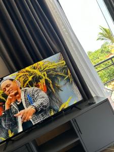 a television with a picture of a man on it at Studio 403 in Kampala