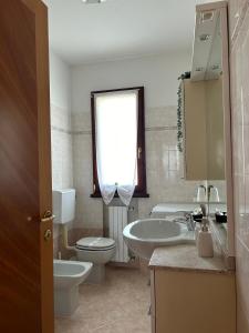 a bathroom with a sink toilet and a window at B&B Gioia in Salsomaggiore Terme +15 photos