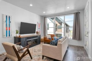a living room with a tv and a couch and chairs at Retro Ski Chalet in Heber City