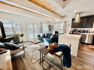 a living room with a couch and a kitchen at Aspen Alcove - Amazing Views Private Hot Tub in Park City