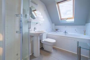 a bathroom with a sink and a toilet and a shower at The Granary, Dunstall Green in Denham +19 photos