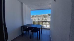 a table and chairs in a room with a window at I love you 203 in Mogán