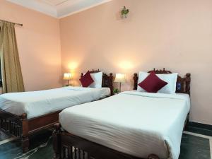 Voodi või voodid majutusasutuse Sajjan Bagh Resort toas