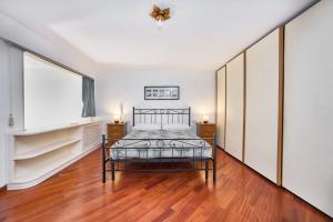 a bedroom with a bed and a large window at Eternal Vatican Apartment EVA in Rome