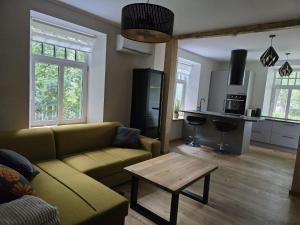 a living room with a couch and a table at Endla appartement in Viljandi