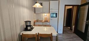 a kitchen with a table with a coffee maker on it at Apartment 3 115 in Goslar