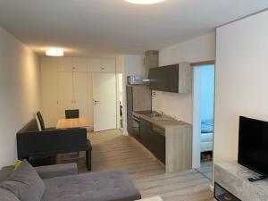 a room with a kitchen and a living room with a couch at Apartment 3 502 in Goslar