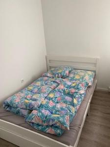 a bed with a comforter on it in a bedroom at Apartment 3 502 in Goslar