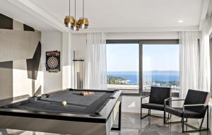 a billiard room with a pool table and two chairs at Stunning Home In Makarska With Sauna in Makarska