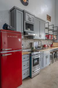 a kitchen with a red refrigerator and a table at Stevie Ray In The Hill Country - Hacienda Amor in Johnson City