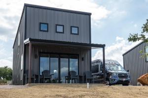 a house with chairs and a truck parked next to it at Stevie Ray In The Hill Country - Hacienda Amor in Johnson City +8 photos