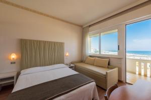 Postel nebo postele na pokoji v ubytování Hotel Benini