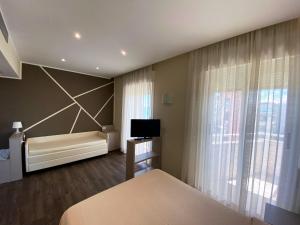 Postel nebo postele na pokoji v ubytování Hotel Benini