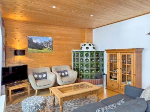 a living room with a couch and a table at Haus Klinsterwald in Sankt Oswald