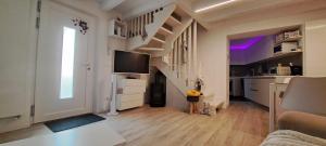 a living room with a staircase with a tv in it at Chalet BORGO PRA' in Belluno