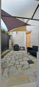 a patio with awning and two chairs and a table at Chalet BORGO PRA' in Belluno +3 photos