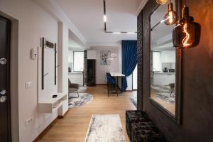 a hallway with a mirror and a living room at Best House in Botoşani