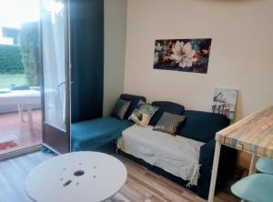 a living room with a couch and a table at Petit nid douillet in Argelès-sur-Mer