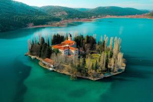 an island in the middle of a large body of water at Oliane Rooms & Accommodation in Bribir +10 photos