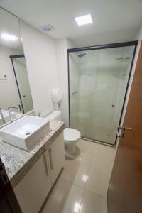 a bathroom with a sink and a toilet and a shower at Gold flat praia de cabo branco in João Pessoa +13 photos