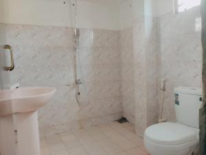 a bathroom with a shower and a toilet and a sink at Villa Aroma Ahangama in Ahangama