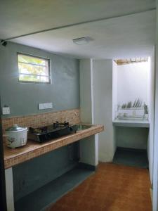 a kitchen with a counter and a sink and a window at Villa Aroma Ahangama in Ahangama +16 photos