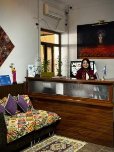 a woman is standing behind a counter in a store at BESQALA in Nukus