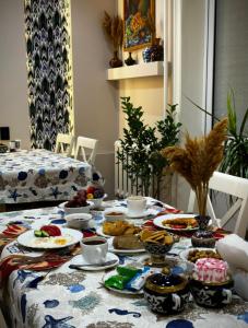a table with plates of food on top of it at BESQALA in Nukus