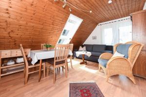 a living room with a table and chairs and a couch at Ferienhof Ennenhof in Gastriege