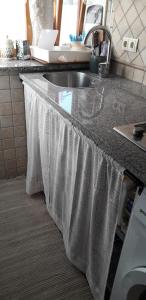 a kitchen counter with a sink with a white towel on it at Dora in Kraljevica