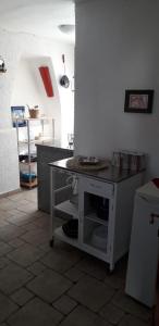 a kitchen with a counter and a table in a room at Dora in Kraljevica