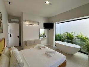 a bathroom with a bath tub and a large window at Ashta Suites - Nora Suite in Fethiye +27 photos