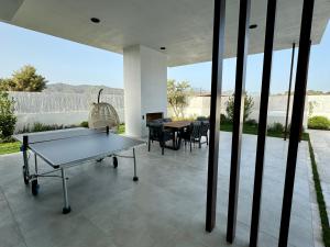 a ping pong table in the middle of a patio at Ashta Suites - Nora Suite in Fethiye