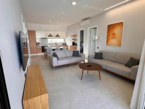 a living room with two couches and a table at Ashta Suites - Nora Suite in Fethiye