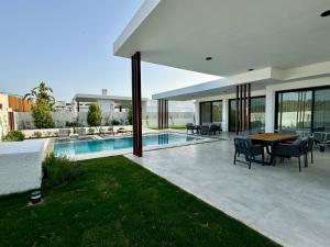 a villa with a swimming pool and a patio at Ashta Suites - Nora Suite in Fethiye