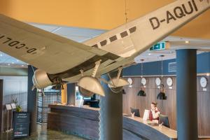 an airplane hanging from the ceiling of a restaurant at Airways Hotels Frankfurt Airport West in Raunheim +62 photos