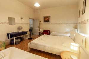pokój hotelowy z 2 łóżkami i pianinem w obiekcie Soggiorno Primavera we Florencji