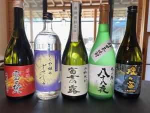 four bottles of wine sitting on a table at すいこうえんさくら in Fujinomiya