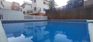 a swimming pool in front of a building at Sentir CAZORLA in Cazorla