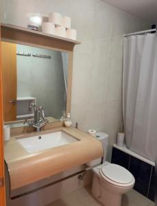 a bathroom with a sink and a toilet and a mirror at apartamento 4 in Benicarló +13 photos