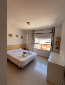 a bedroom with a bed and a large window at apartamento 4 in Benicarló