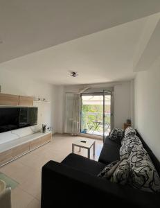 a living room with a couch and a tv at apartamento 4 in Benicarló