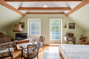 a bedroom with a bed and a living room at Provincija in Palanga