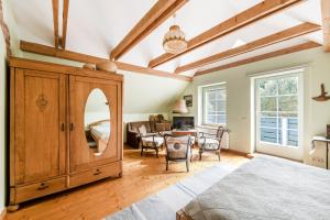 a room with a large wooden cabinet with a mirror at Provincija in Palanga