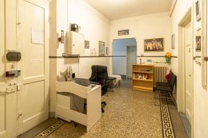 a room with a office with a desk and chairs at Soggiorno Primavera in Florence