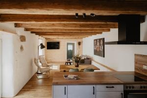 a kitchen and living room with wooden ceilings at Ferienhaus Lindenglück in Löffingen