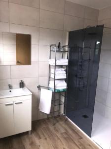 a bathroom with a shower and a sink and towels at Casa Aricel VT in Chantada +8 photos