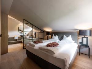 A bed or beds in a room at Sportony Mountain Lodges