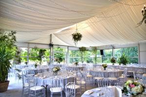 a banquet hall with white tables and chairs at Chateau De Montreuil in Montreuil-sur-Mer